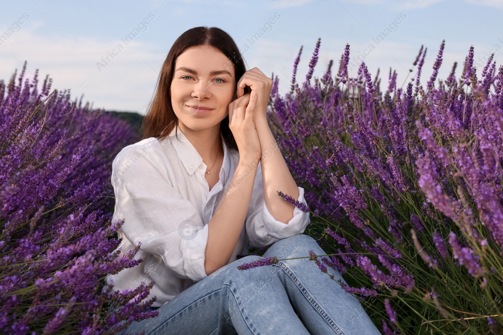 Photo of Portrait of beautiful young woman in lavender field