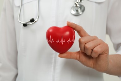 Doctor holding red heart, closeup. Cardiology concept