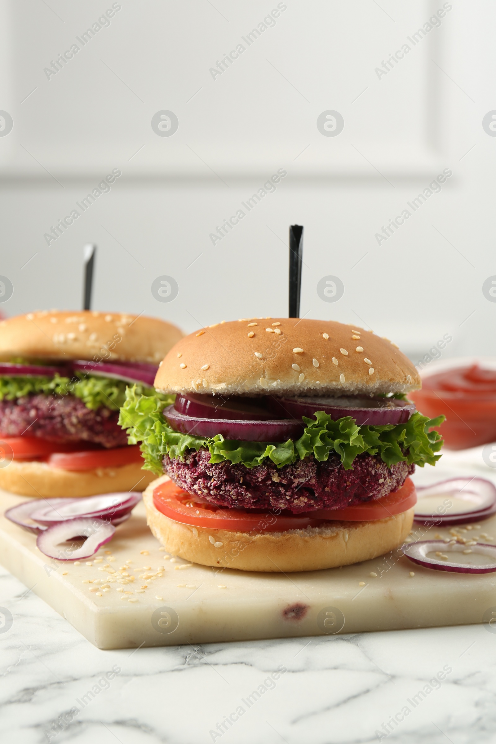 Photo of Tasty vegetarian burgers with beet patties on white marble table