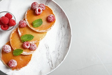 Photo of Tasty pancakes with berries on plate, top view