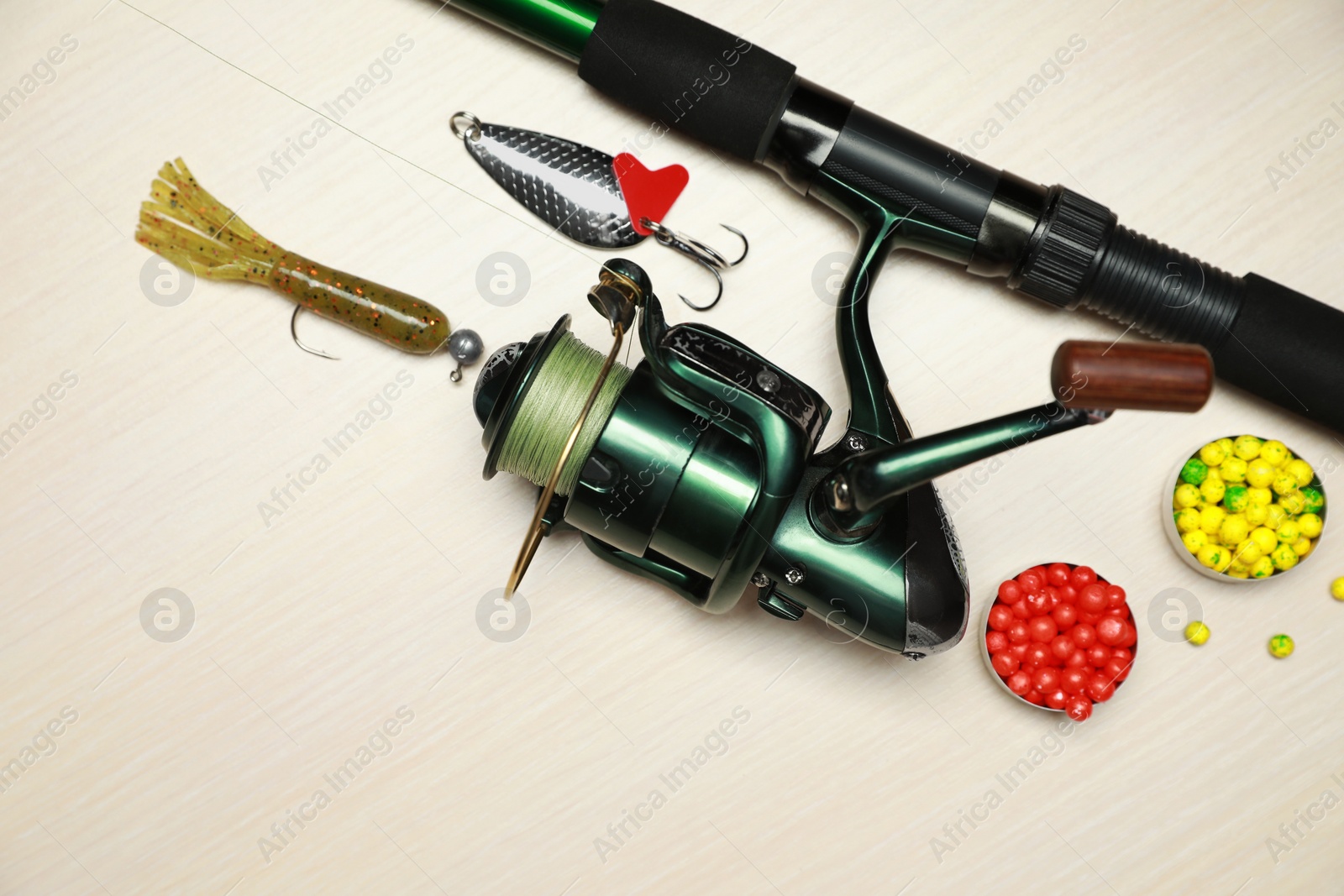 Photo of Fishing tackle on wooden background, flat lay. Space for text