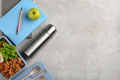 Photo of Flat lay composition with thermos and food on light grey table. Space for text