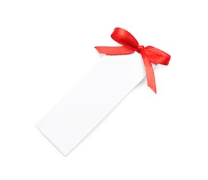 Blank gift tag with red satin ribbon on white background, top view. Space for design