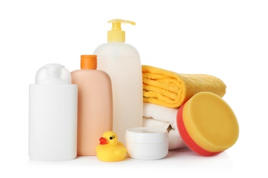 Photo of Baby cosmetic products, toy and towels on white background