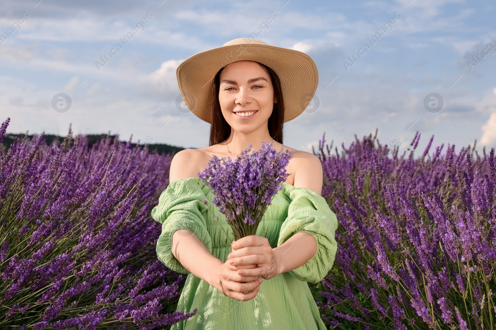 Photo of Smiling woman with bouquet in lavender field