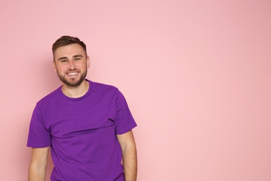 Photo of Portrait of young man laughing on color background. Space for text