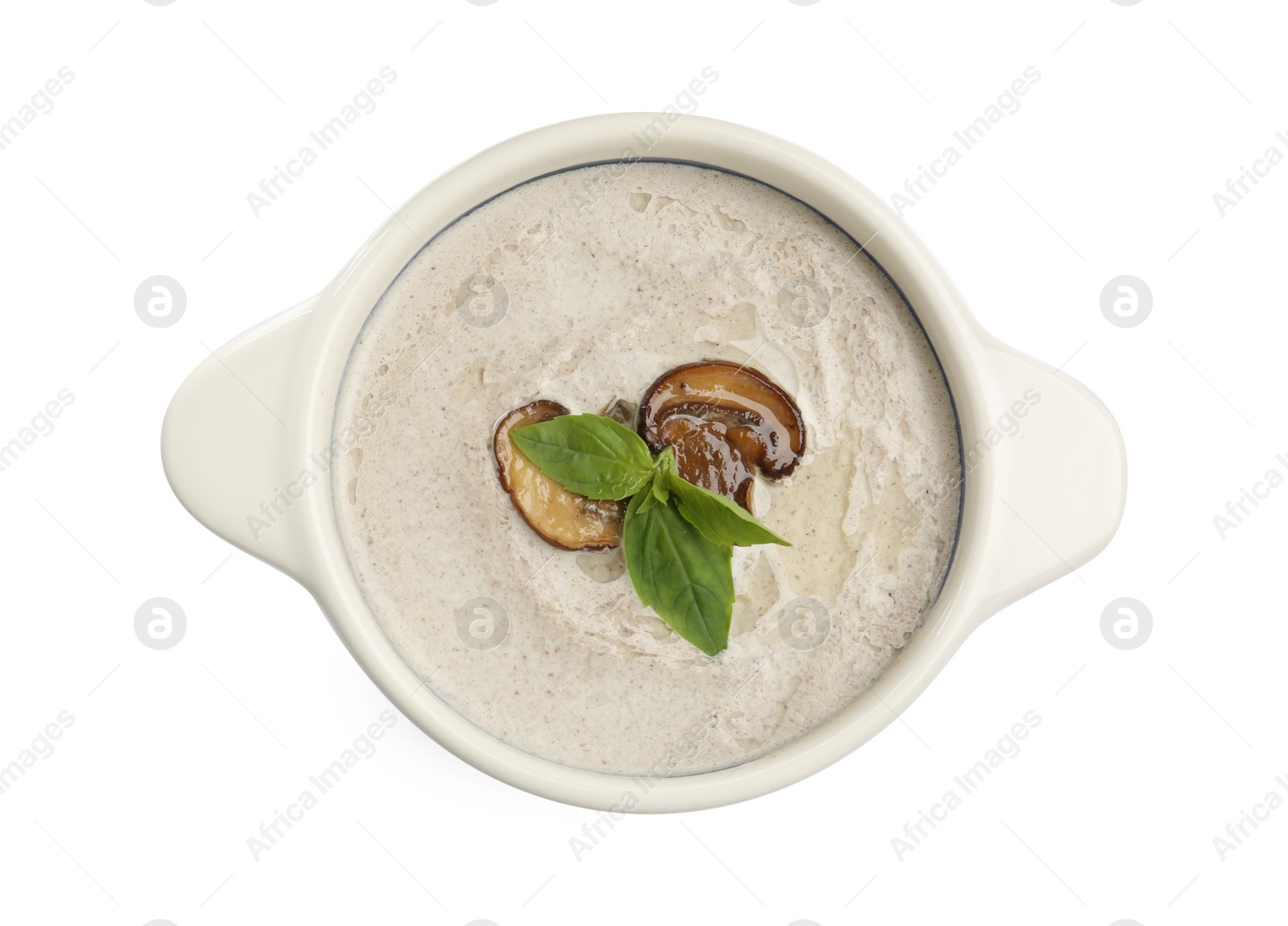 Photo of Fresh homemade mushroom soup in ceramic pot isolated on white, top view