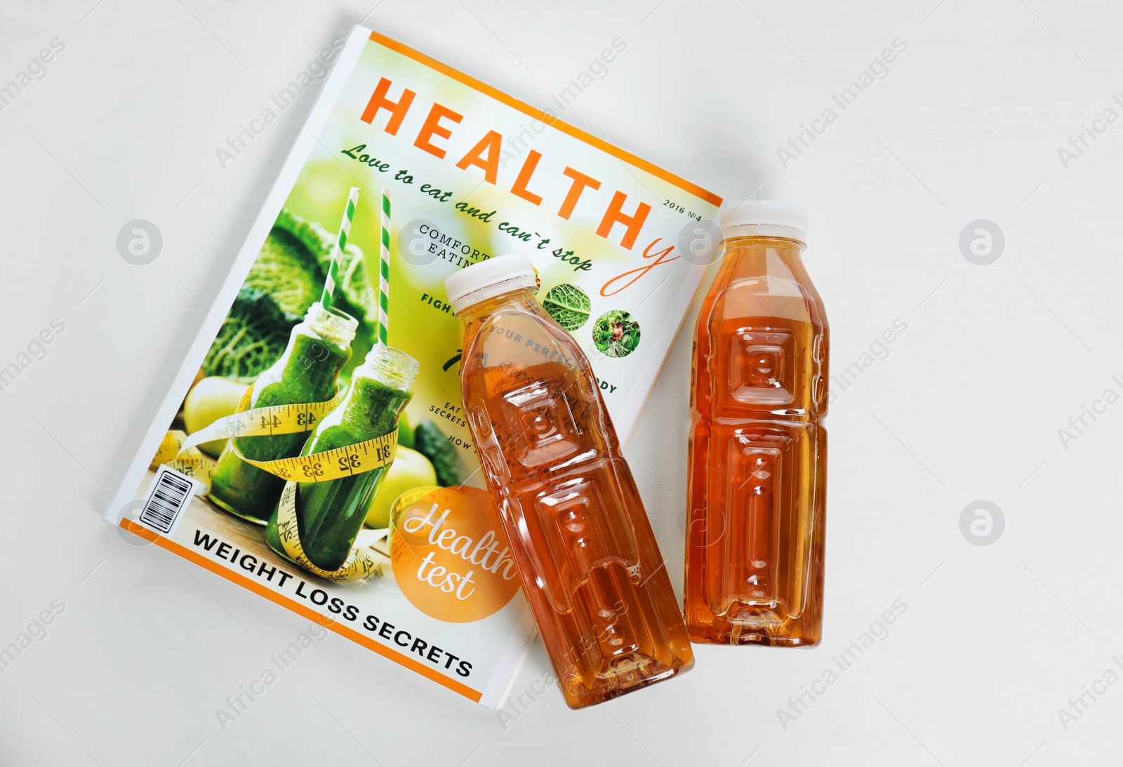 Photo of Bottles of apple juice on white background, top view