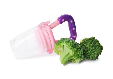 Photo of Empty nibbler and boiled broccoli on white background. Baby feeder