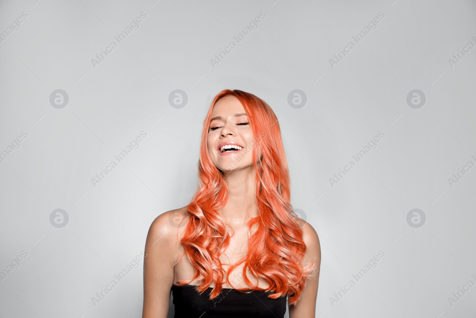 Image of Beautiful woman with long orange hair on light background