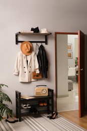 Hallway interior with stylish furniture, clothes and accessories