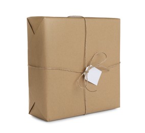 Parcel wrapped in kraft paper with tag on white background