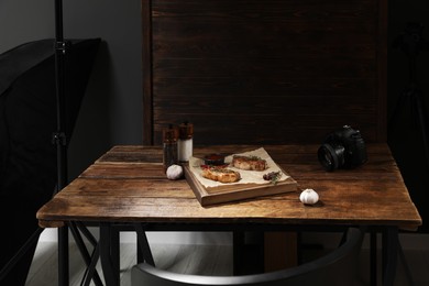 Photo of Professional equipment and composition with meat medallions on table in studio. Food photography