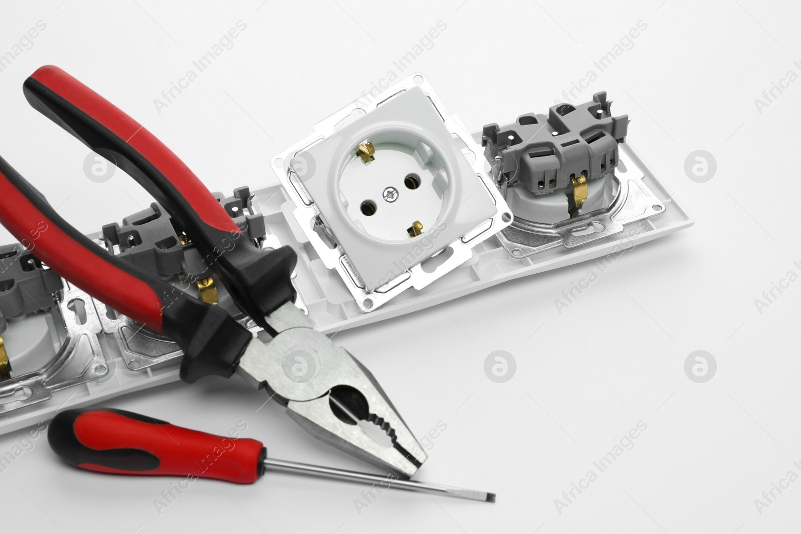 Photo of Set of sockets and electrician's tools on white background