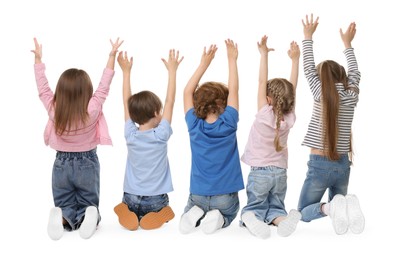 Group of children posing on white background, back view