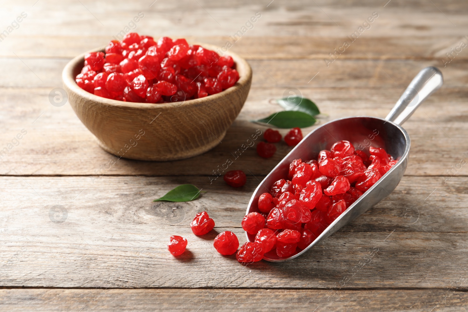 Photo of Scoop and bowl of sweet cherries on wooden background. Dried fruit as healthy snack