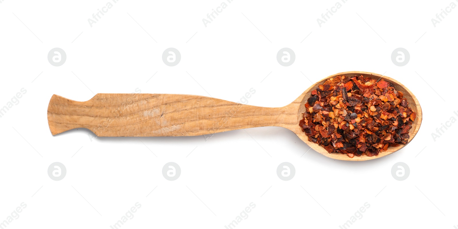 Photo of Wooden spoon with dried chopped chili pepper on white background. Different spices