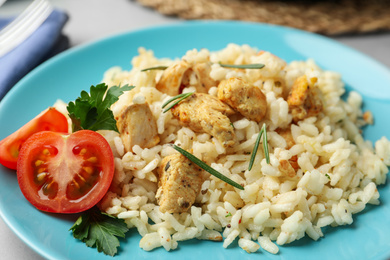 Delicious risotto with chicken on plate, closeup