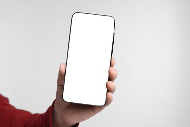 Photo of Man showing smartphone on white background, closeup. Mockup for design