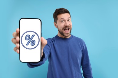 Discount, offer, sale. Emotional man showing mobile phone with percent sign on screen, background