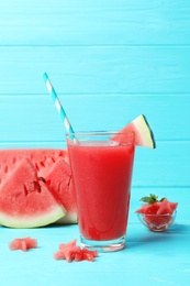 Photo of Summer watermelon drink in glass and sliced fruit on table