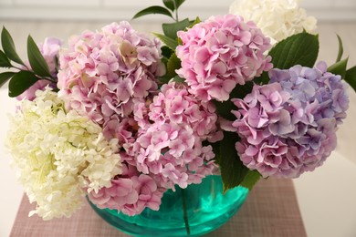 Photo of Bouquet of beautiful hydrangea flowers on table, closeup