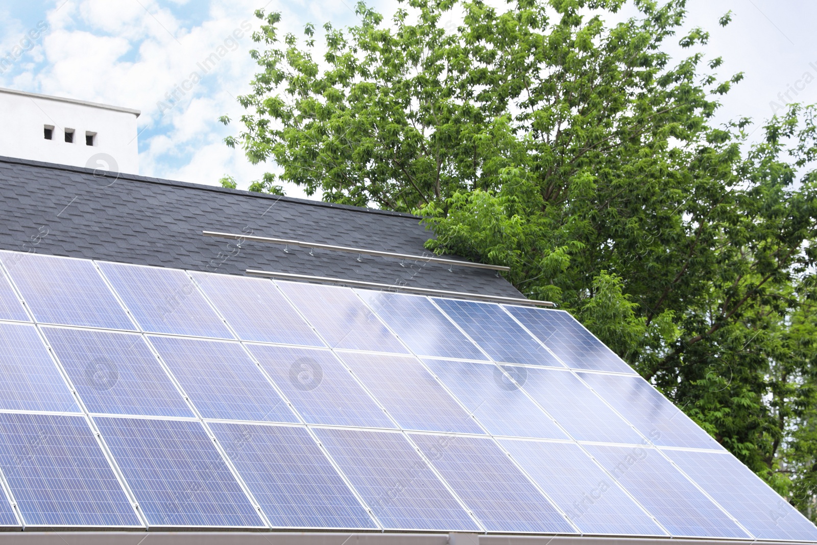 Photo of Building with installed solar panels on roof. Alternative energy source