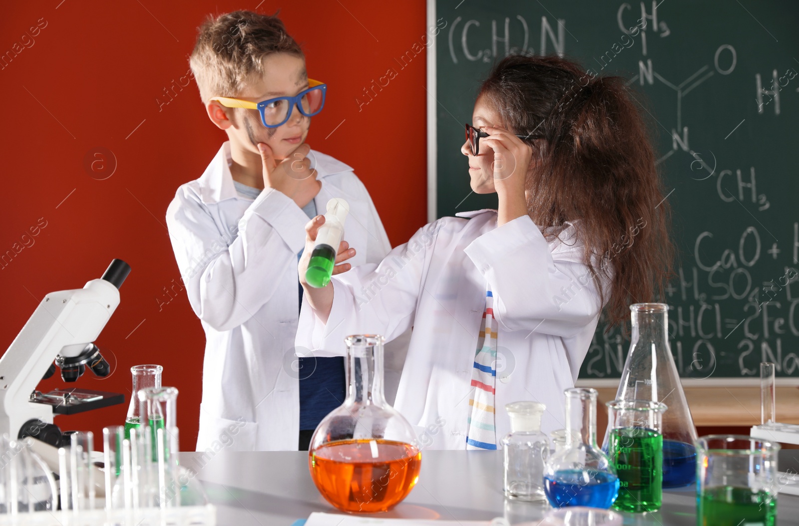 Photo of Children doing chemical research in laboratory. Dangerous experiment