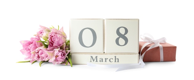 Photo of Wooden block calendar with date 8th of March, gift and tulips on white background. International Women's Day