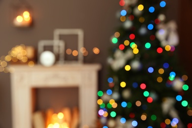 Photo of Blurred stylish room interior with Christmas tree and decorative fireplace