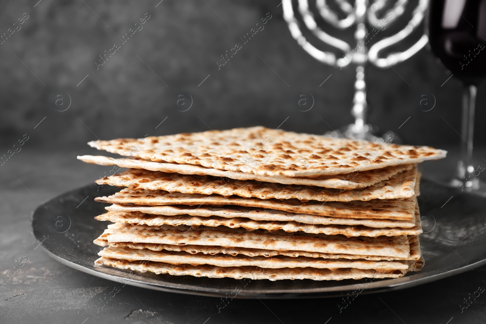 Photo of Stack of matzos on grey table, closeup