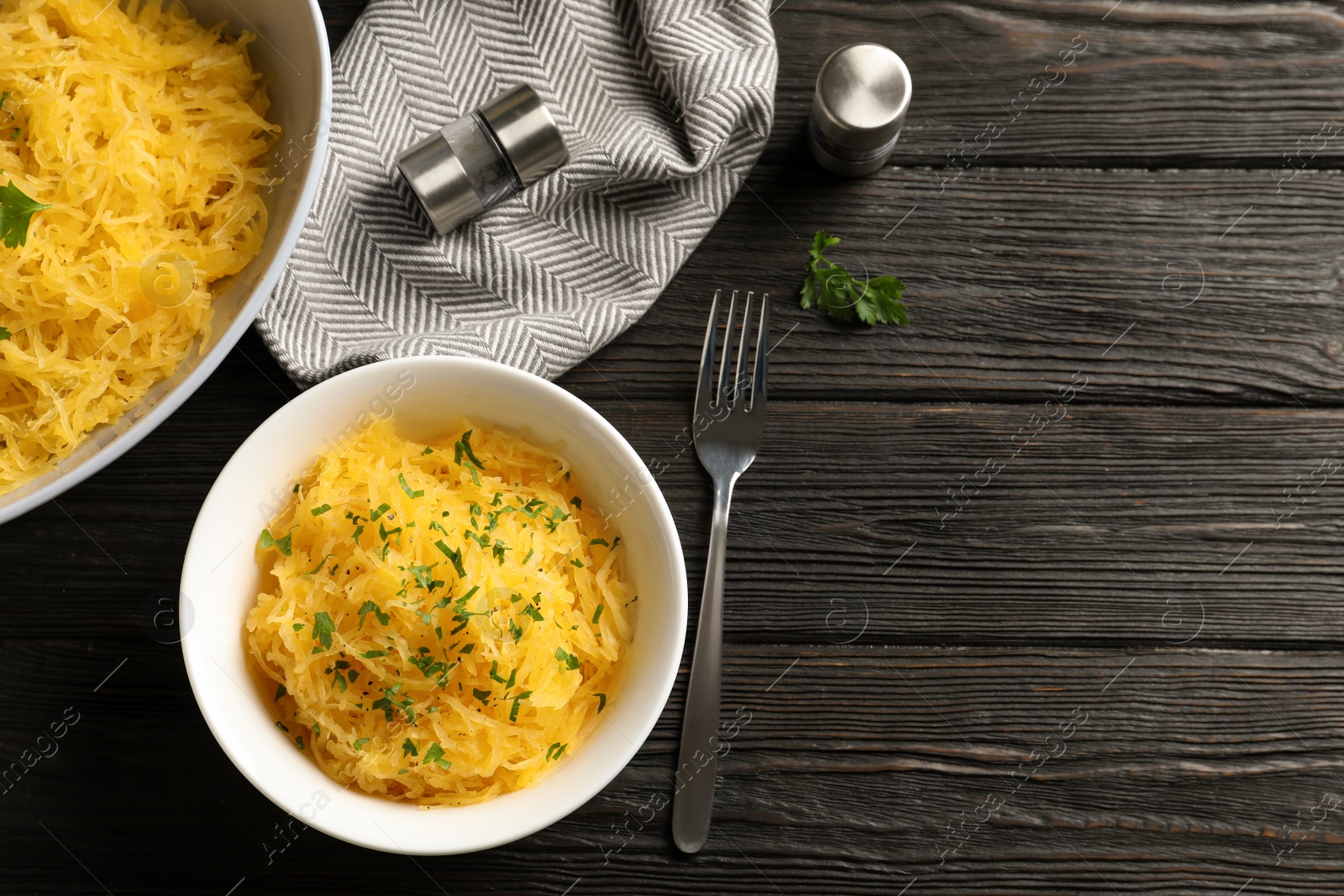 Photo of Flat lay composition with cooked spaghetti squash and space for text on wooden table