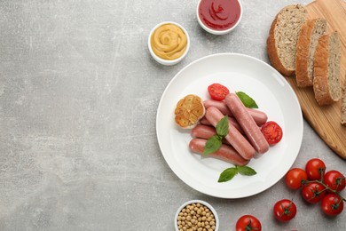 Photo of Flat lay composition with vegetarian sausages and vegetables on grey table. Space for text