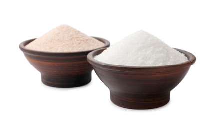 Photo of Different types of natural salt in bowls isolated on white