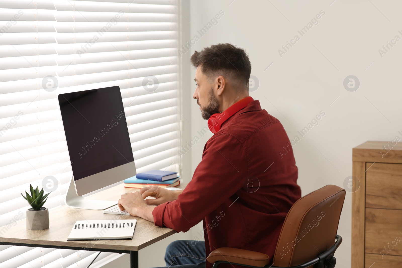 Photo of Man studying on computer at home. Online translation course