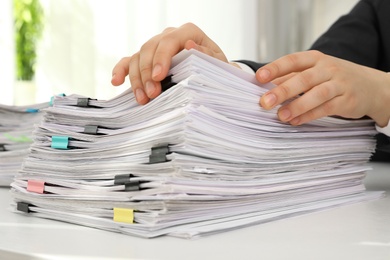 Photo of Woman working with documents at table in office, closeup