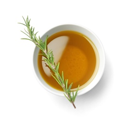 Bowl with rosemary oil on white background, top view