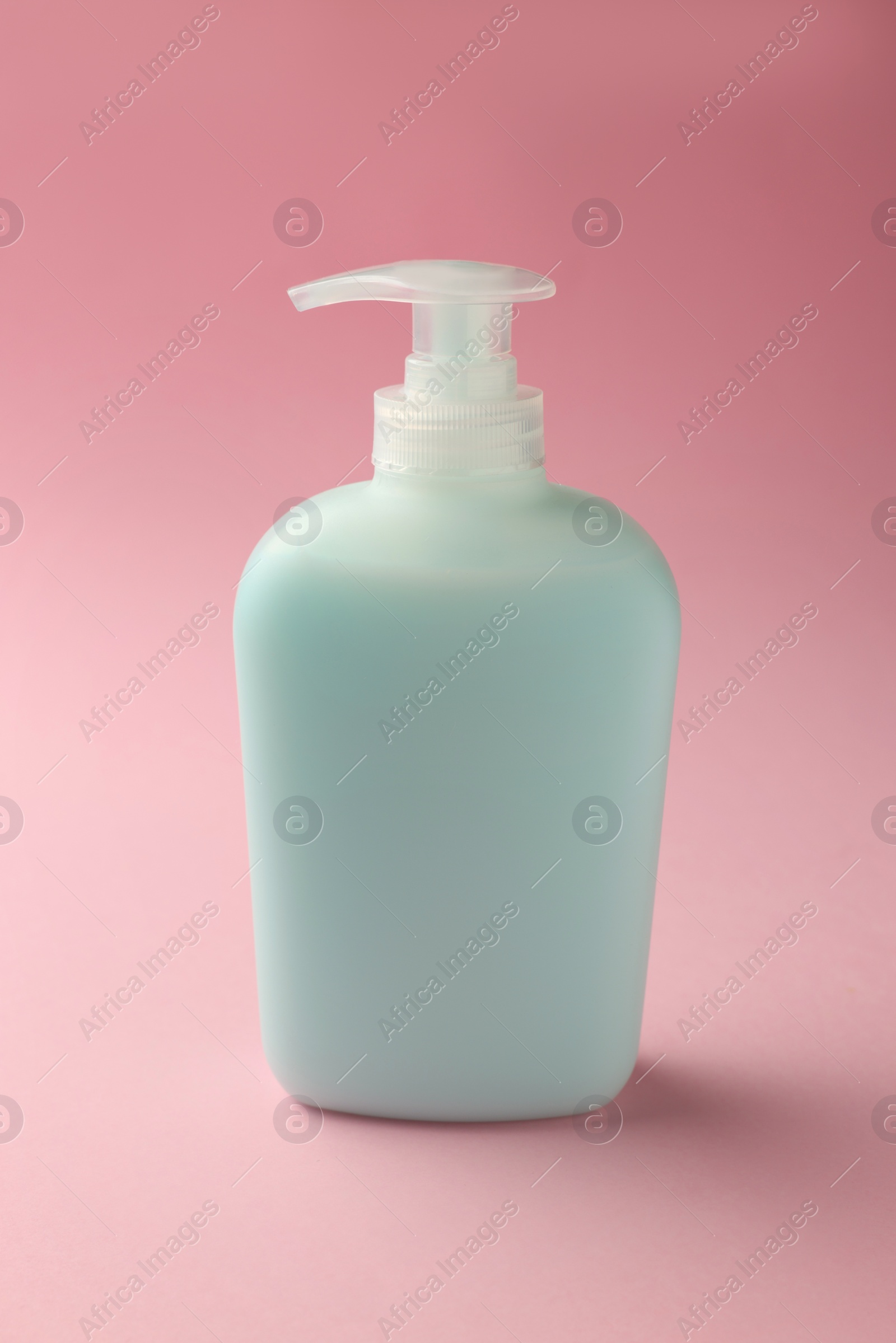 Photo of Bottle of liquid soap on pink background