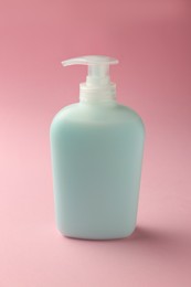 Bottle of liquid soap on pink background