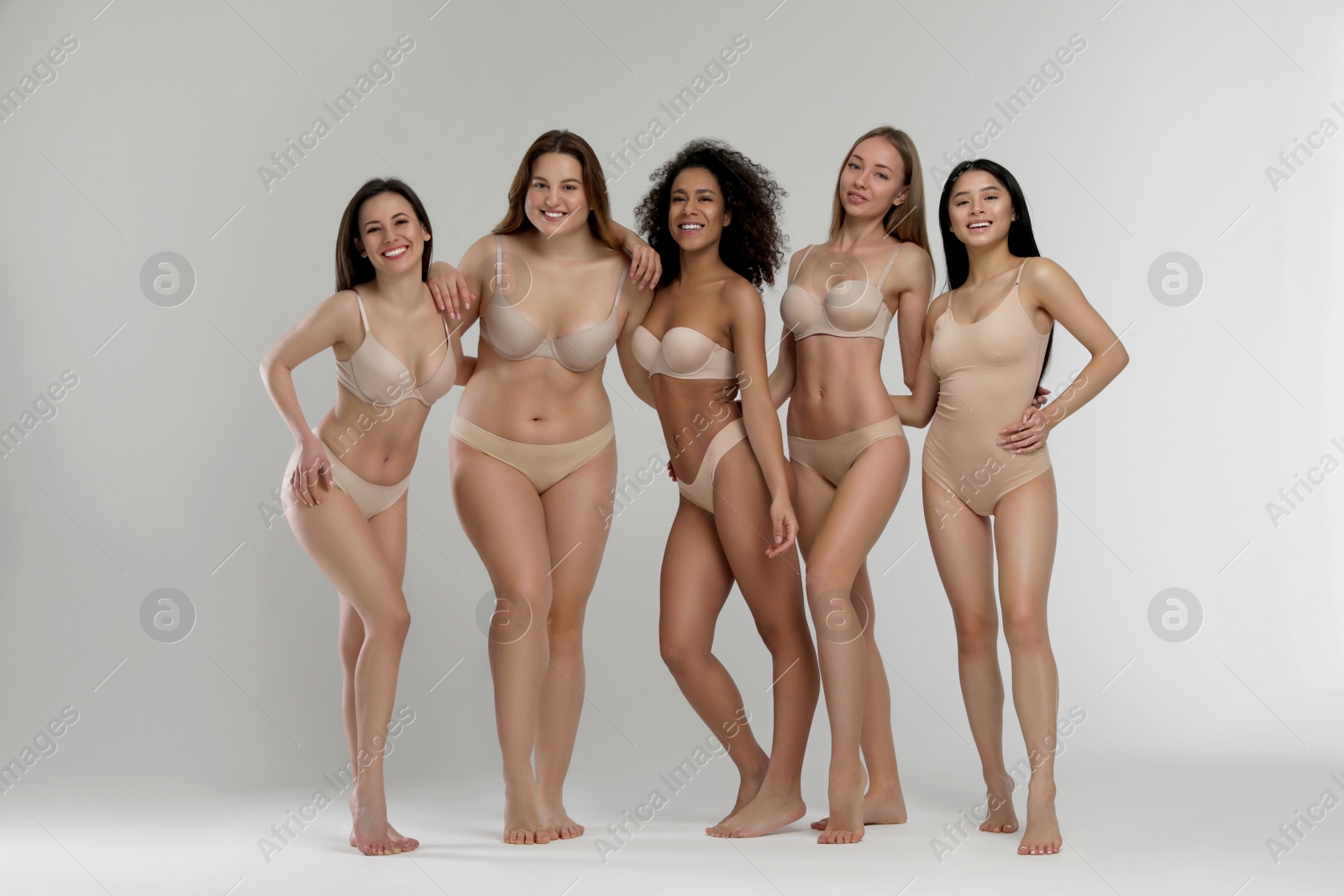 Photo of Group of women with different body types in underwear on light background