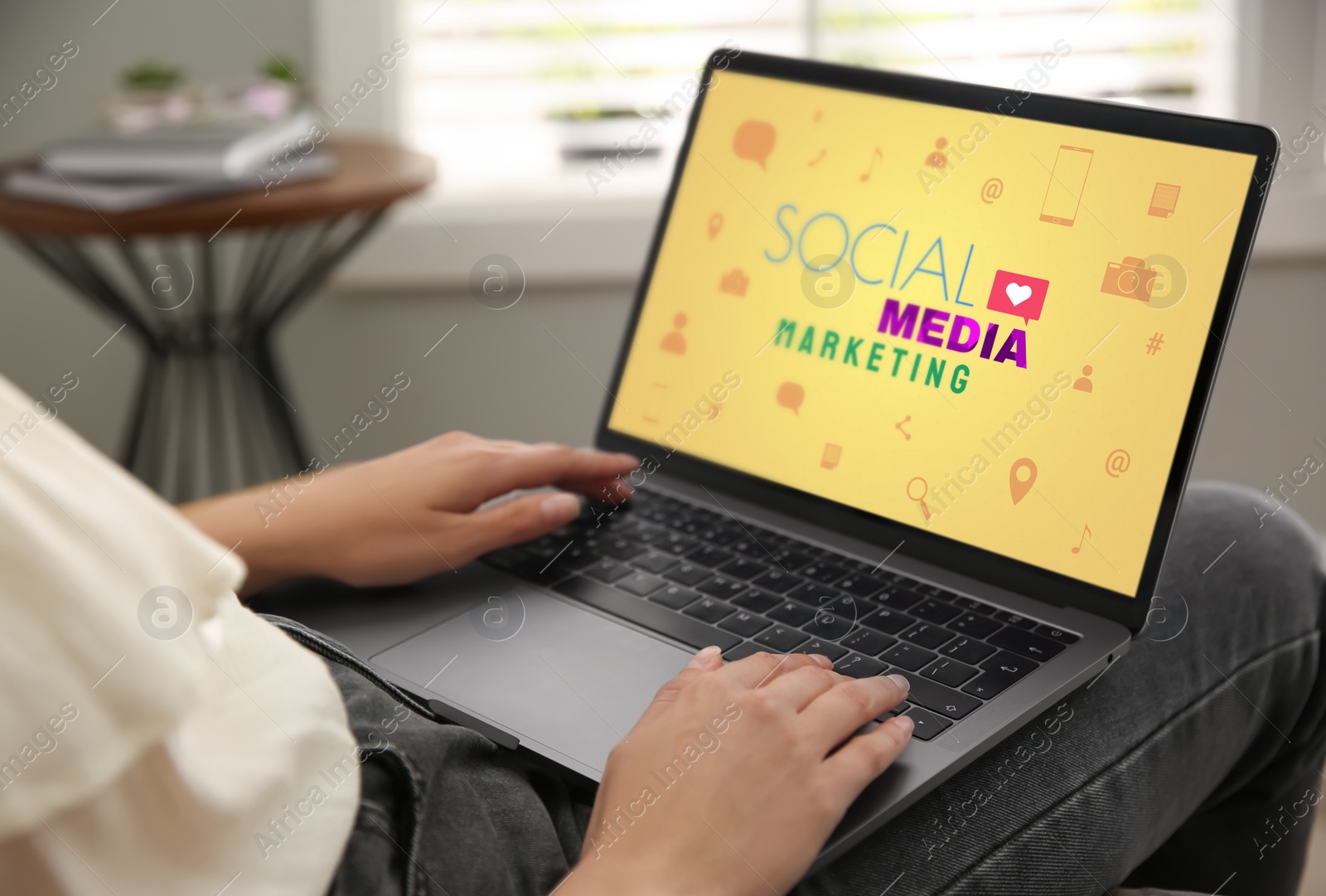 Image of SMM (Social Media Marketing) concept. Woman working with modern laptop indoors, closeup