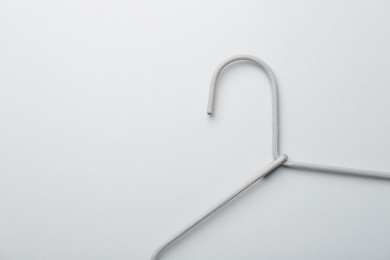 Photo of Hanger on light gray background, top view. Space for text