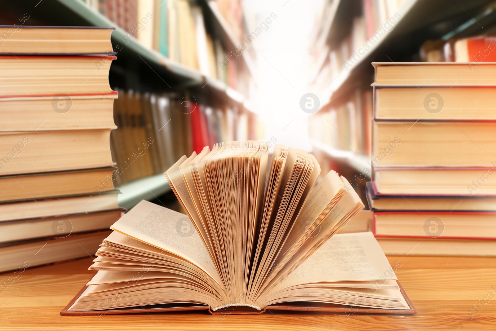 Image of Different books on wooden table in library