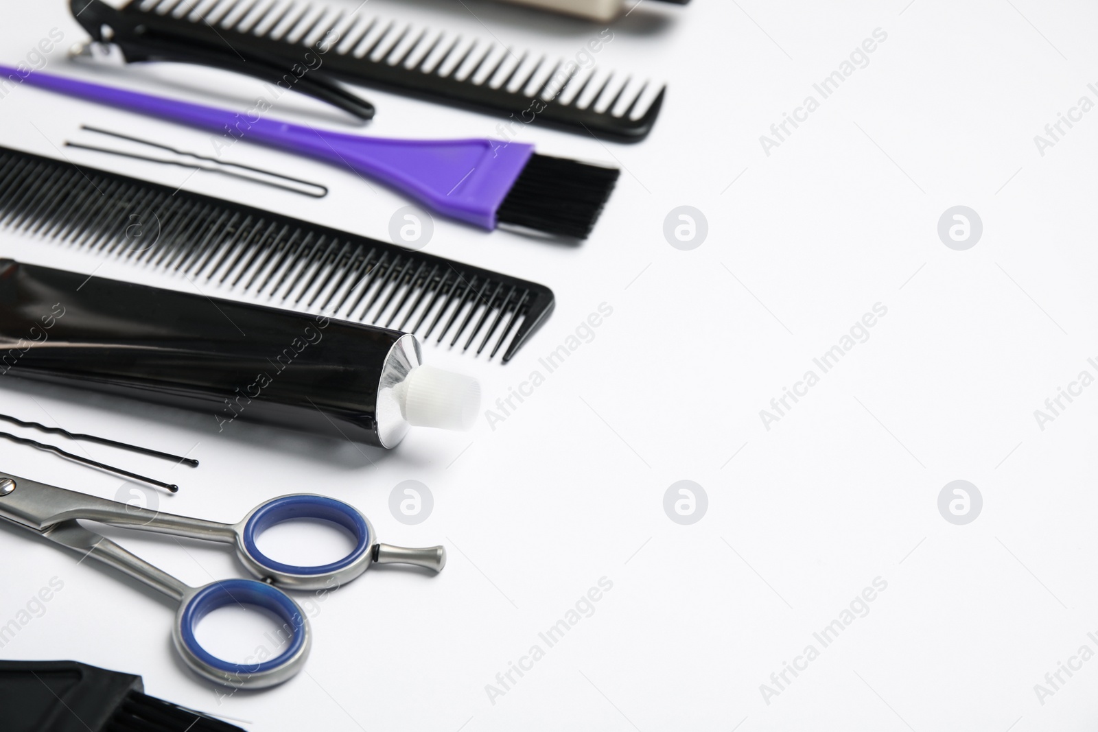 Photo of Professional tools for hair dyeing on white background, space for text