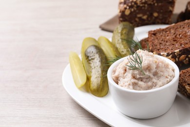 Delicious lard spread, bread and pickles on wooden table. Space for text