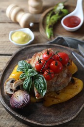 Delicious grilled meat and vegetables served on wooden table, closeup