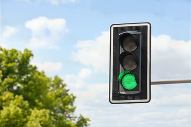 Photo of Traffic light against blue sky, space for text