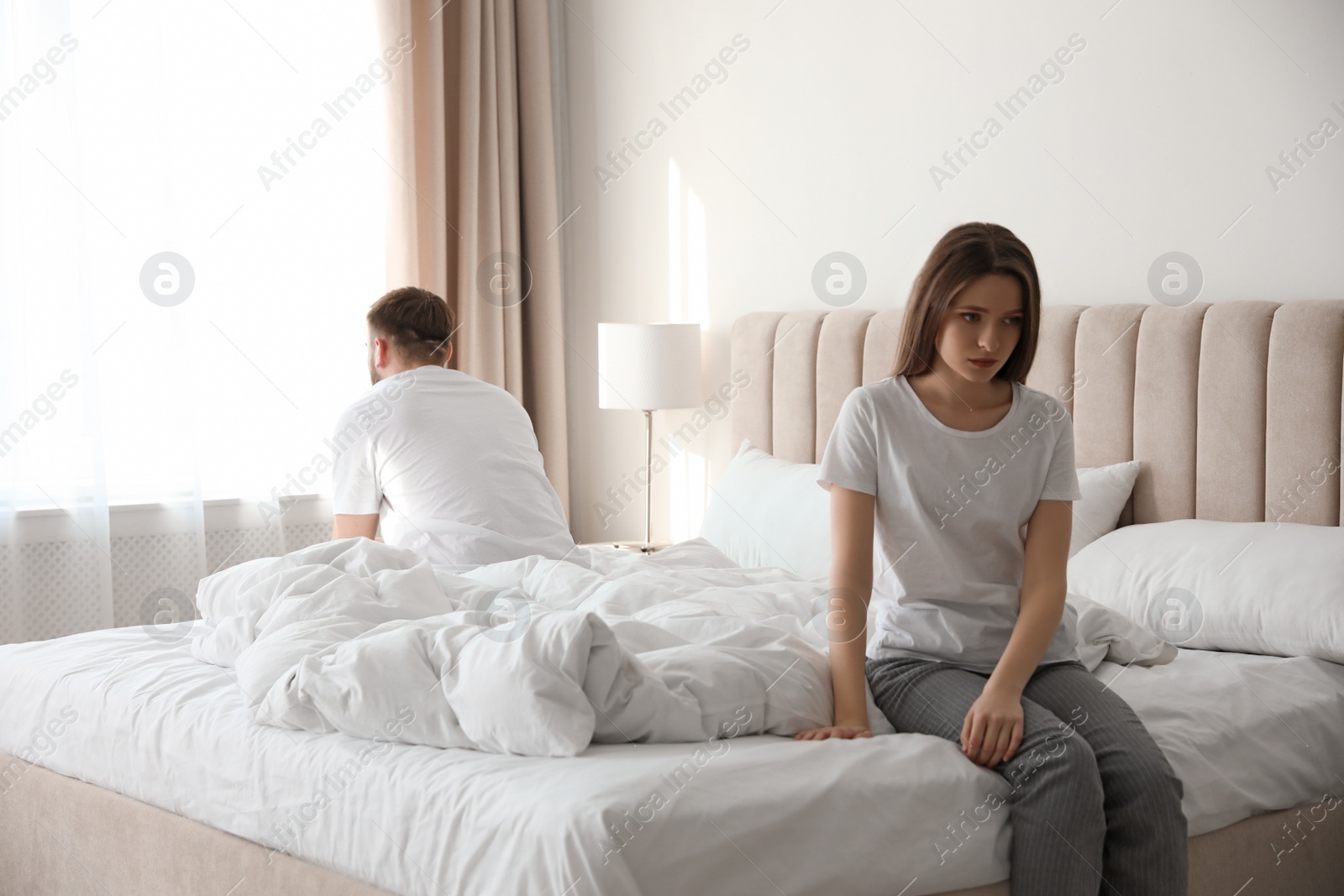 Photo of Unhappy couple with problems in relationship at home