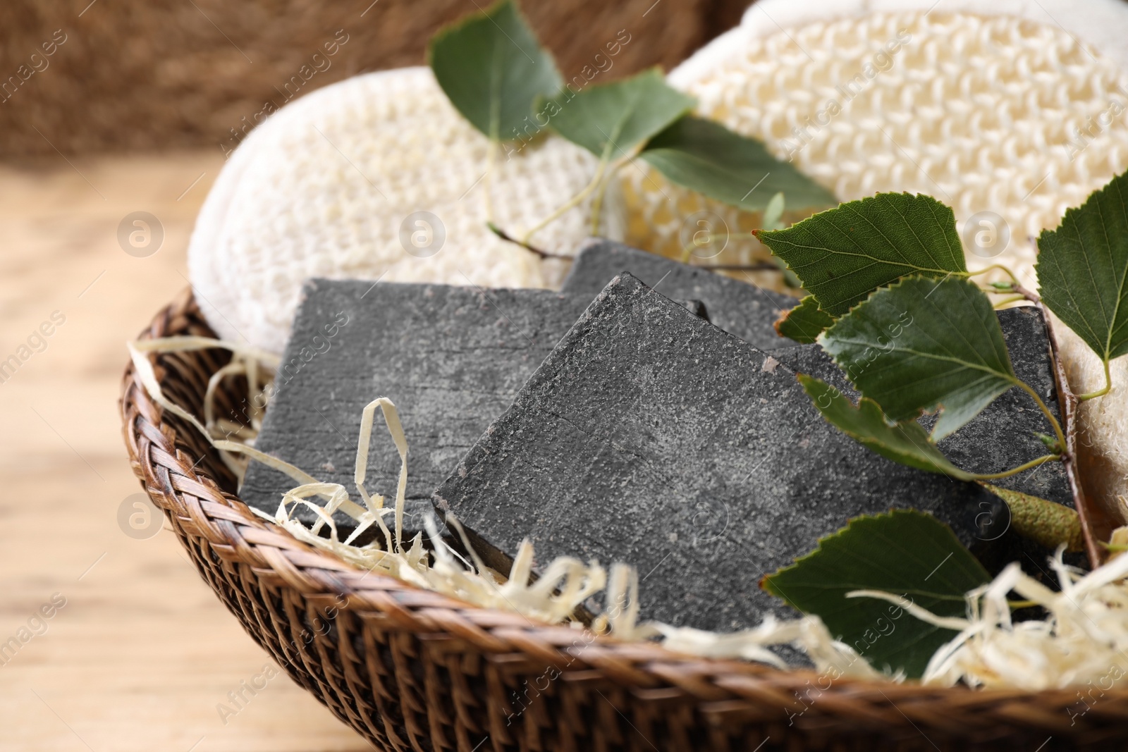 Photo of Natural tar soap in wicker basket, closeup