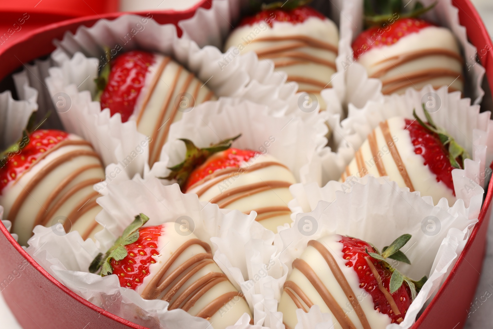 Photo of Delicious chocolate covered strawberries in heart shaped box, closeup